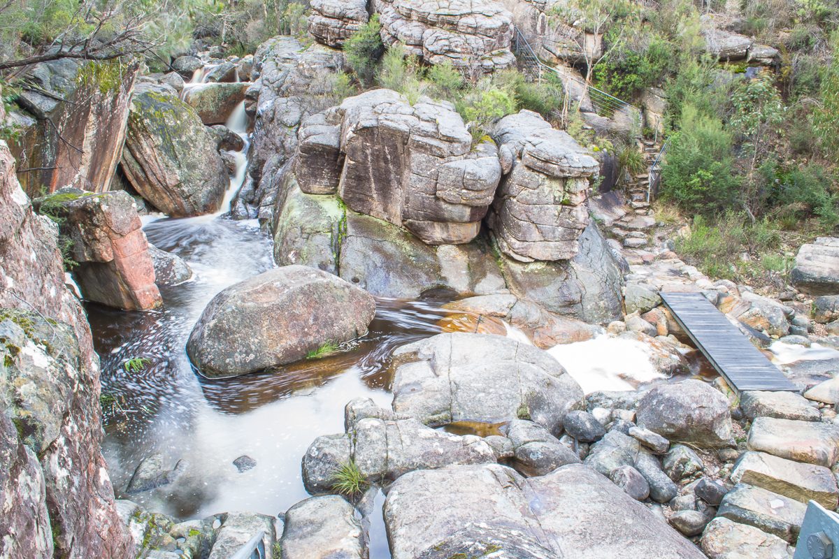 The steep rock steps and footbridge at the bottom of the gorge descent from the Wonderland Carpark