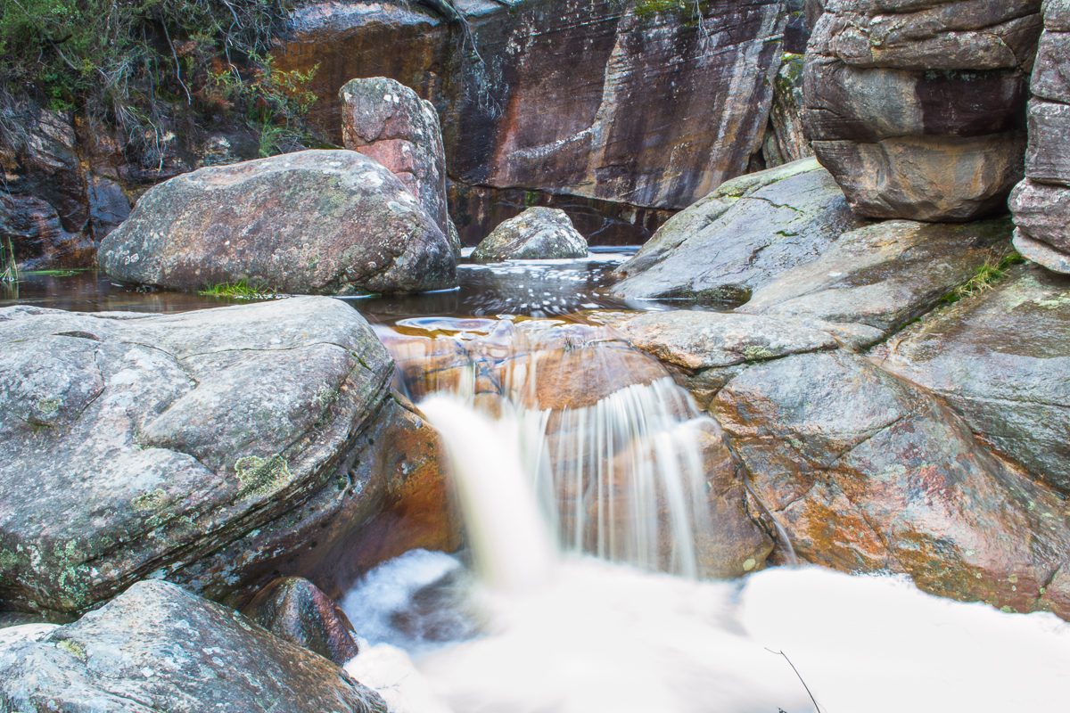 Water cascading over smooth rock pools along the creek near Venus Baths